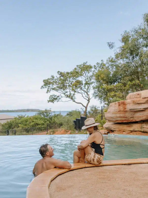 Couple sitting in infinity pool